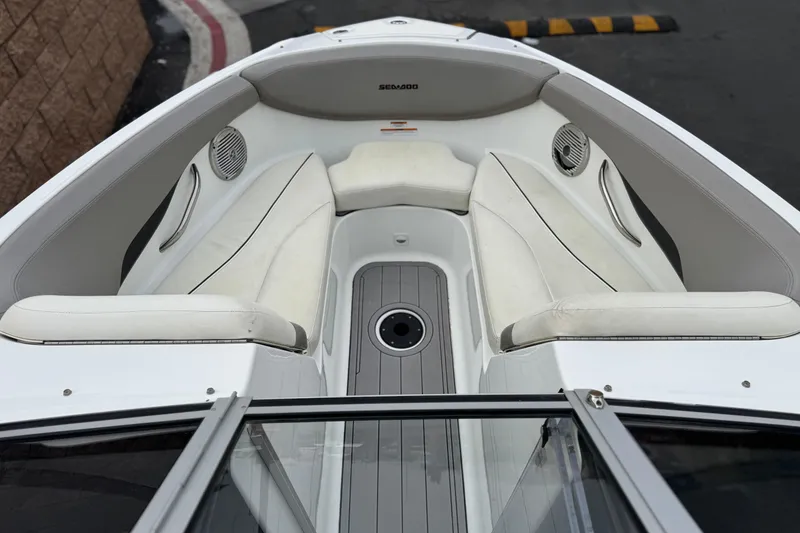 Slide: The Image of 2012 Bombardier Sea Doo 210 Challenger boat interior with white seating and speakers. - 14