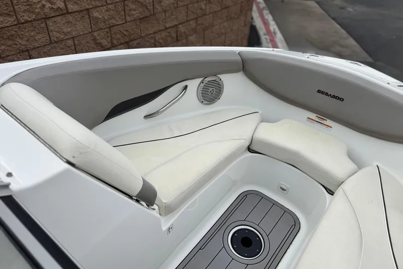 Slide: The Image of 2012 Bombardier Sea Doo 210 Challenger boat interior with white seating and speaker. - 15