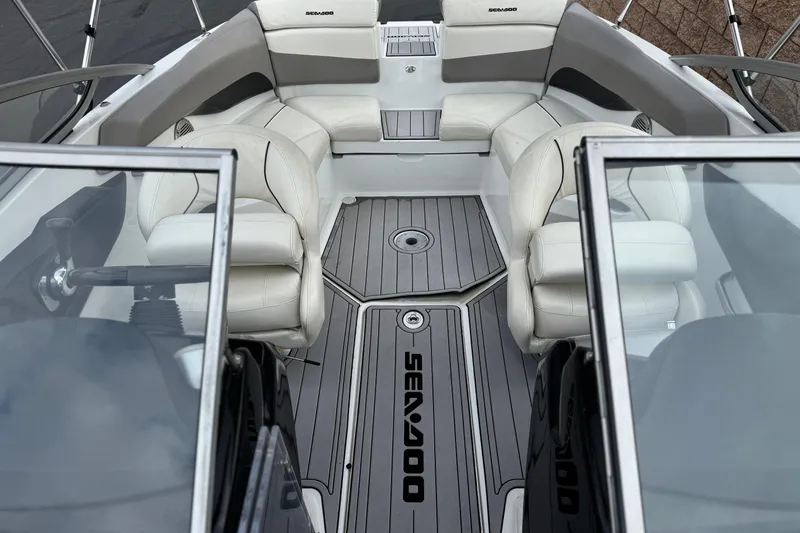 Slide: The Image of 2012 Bombardier Sea Doo 210 Challenger interior with white seating and gray flooring. - 18