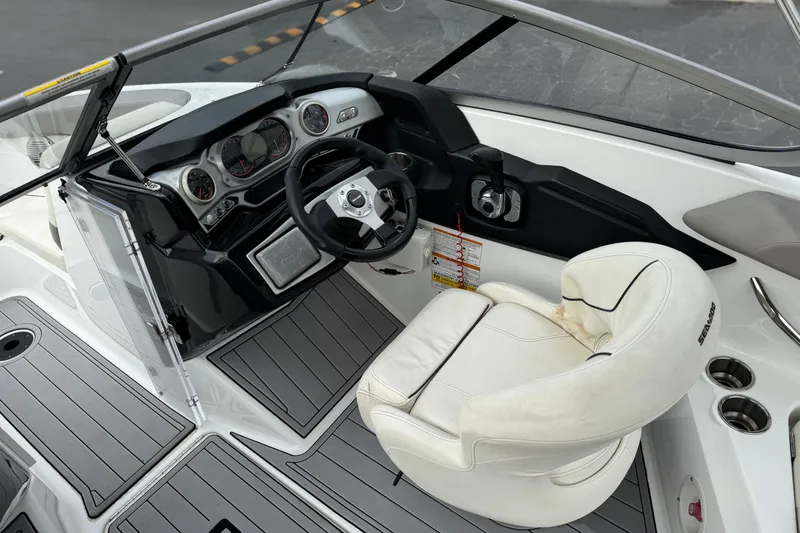 Slide: The Image of Interior of a 2012 Bombardier Sea Doo 210 Challenger boat cockpit with steering wheel. - 24