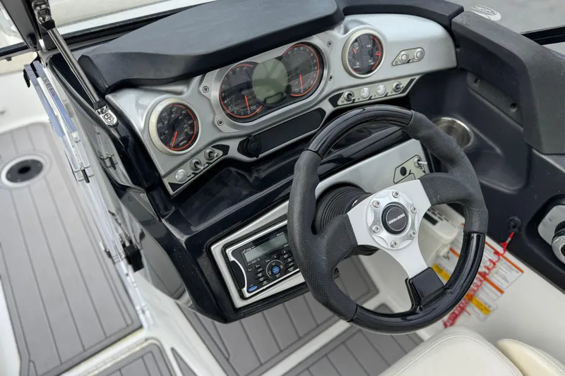 Slide: The Image of 2012 Bombardier Sea Doo 210 Challenger dashboard with steering wheel and control panel. - 26