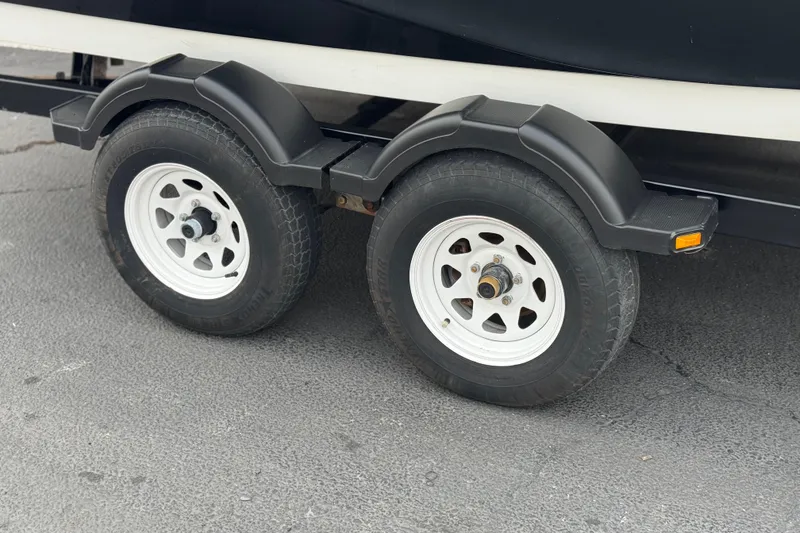 Slide: The Image of Trailer wheels of a 2012 Bombardier Sea Doo 210 Challenger boat. - 28