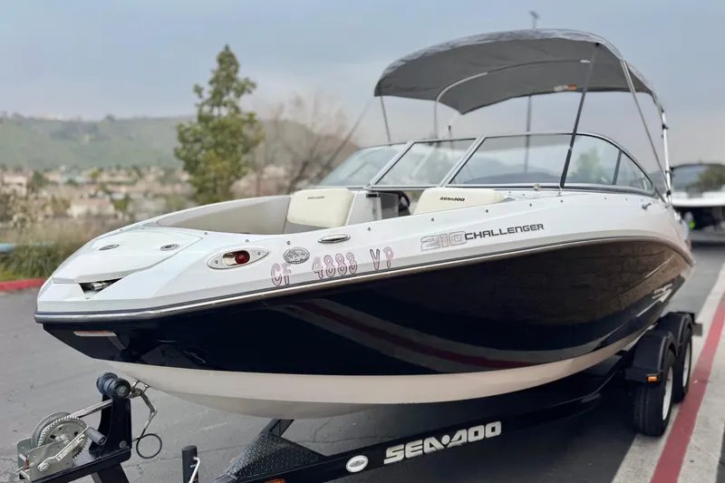 Slide: The Image of 2012 Bombardier Sea Doo 210 Challenger boat on trailer, parked outdoors. - 3