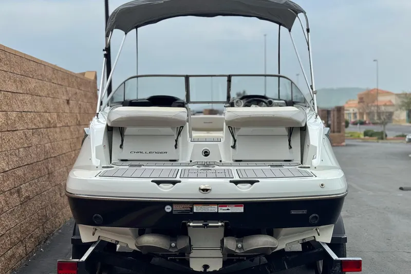 Slide: The Image of 2012 Bombardier Sea Doo 210 Challenger boat, rear view, parked outdoors. - 4