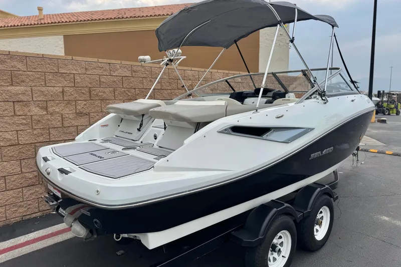 Slide: The Image of 2012 Bombardier Sea Doo 210 Challenger boat on trailer, parked outdoors. - 5