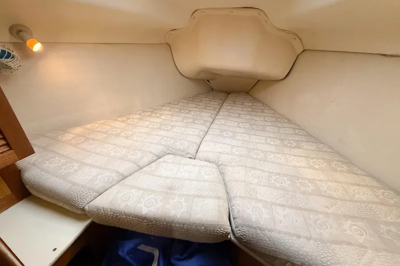 Slide: The Image of Cozy cabin interior of 2001 Hunter 340 sailboat with patterned bedding. - 16