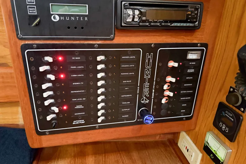 Slide: The Image of Control panel of a 2001 Hunter 340 sailboat with switches and indicators. - 19