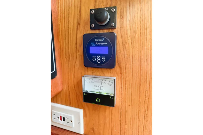 Slide: The Image of Control panel on a 2001 Hunter 340 sailboat with voltmeter and Victron Energy display. - 20