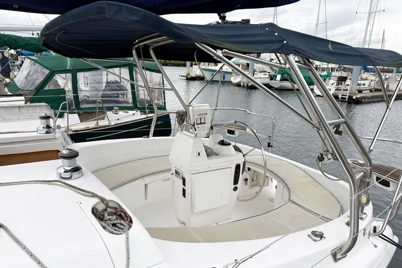 Slide: The Image of Sailboat cockpit of 2001 Hunter 340, featuring steering wheel and canopy in marina setting. - 28