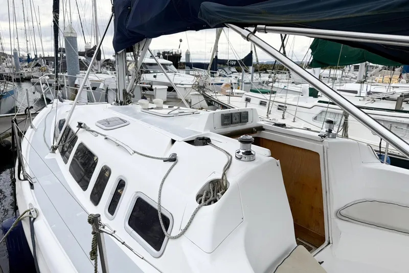 Slide: The Image of 2001 Hunter 340 sailboat docked at marina, showcasing deck and rigging. - 29