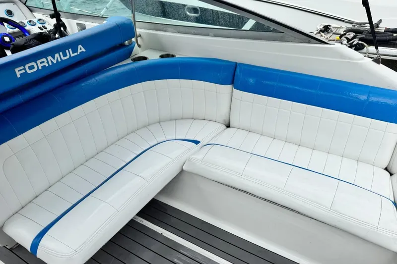 Slide: The Image of 1998 Formula 330 Sun Sport boat interior with blue and white seating. - 12