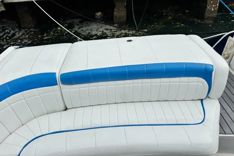 Slide: The Image of 1998 Formula 330 Sun Sport boat seating with white and blue upholstery. - 13