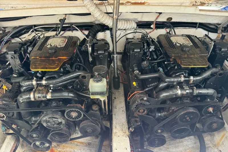 Slide: The Image of Twin engines of a 1998 Formula 330 Sun Sport boat, showcasing detailed mechanics. - 14