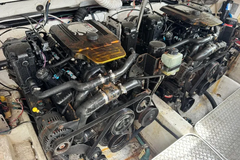 Slide: The Image of Engine compartment of a 1998 Formula 330 Sun Sport boat, featuring dual engines. - 16