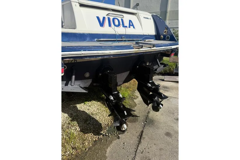 Slide: The Image of 1998 Formula 330 Sun Sport boat rear view with dual propellers. - 17