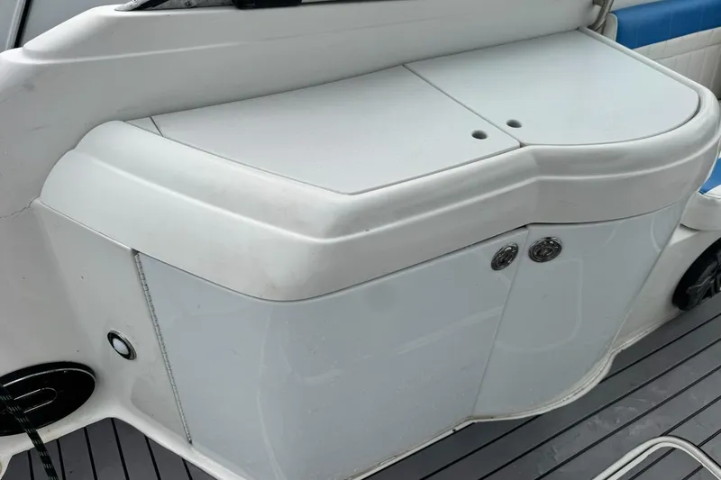 Slide: The Image of 1998 Formula 330 Sun Sport boat interior with white storage compartment and sleek design. - 8