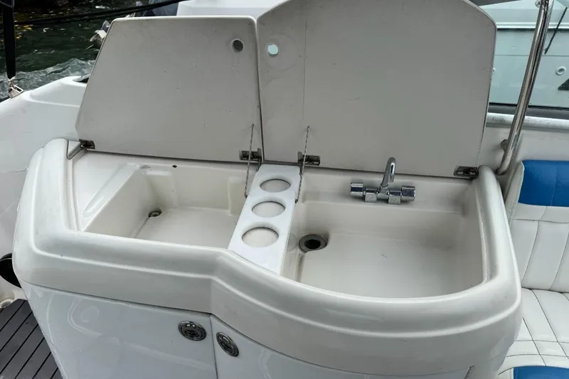 Slide: The Image of 1998 Formula 330 Sun Sport boat sink with faucet and cup holders. - 9