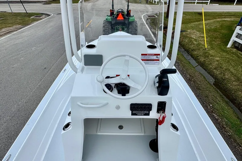 Slide: The Image of 2026 Shallow Sport 24 Modified V boat console with steering wheel and controls. - 10