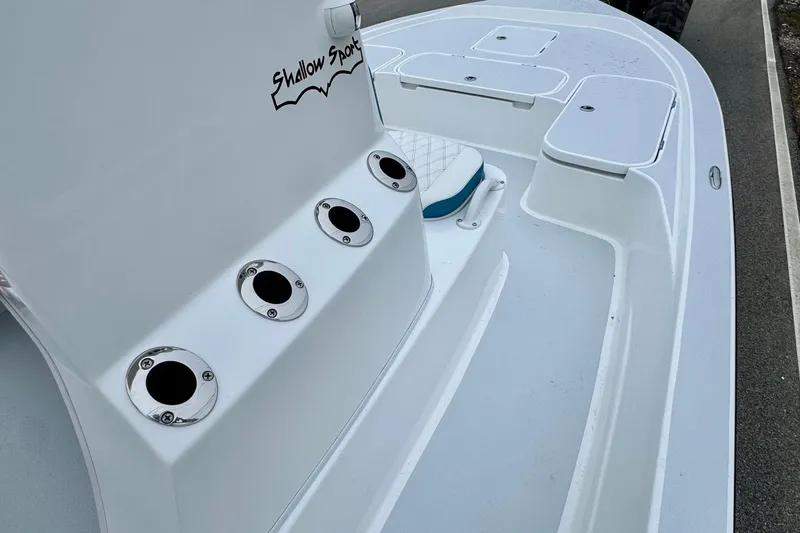 Slide: The Image of 2026 Shallow Sport 24 Modified V boat deck with rod holders and seating. - 13