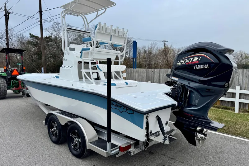 Slide: The Image of 2026 Shallow Sport 24 Modified V boat with Yamaha engine on trailer. - 2
