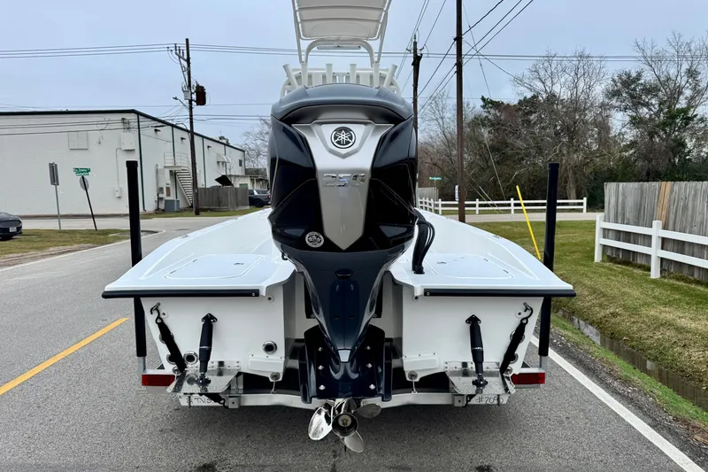 Slide: The Image of 2026 Shallow Sport 24 Modified V boat with powerful outboard motor on a street. - 3