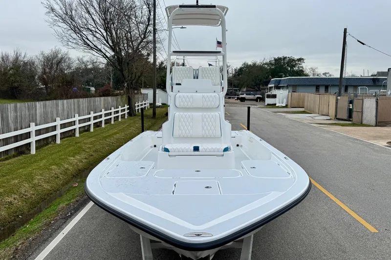 Slide: The Image of 2026 Shallow Sport 24 Modified V boat on a street, showcasing sleek design and spacious deck. - 6