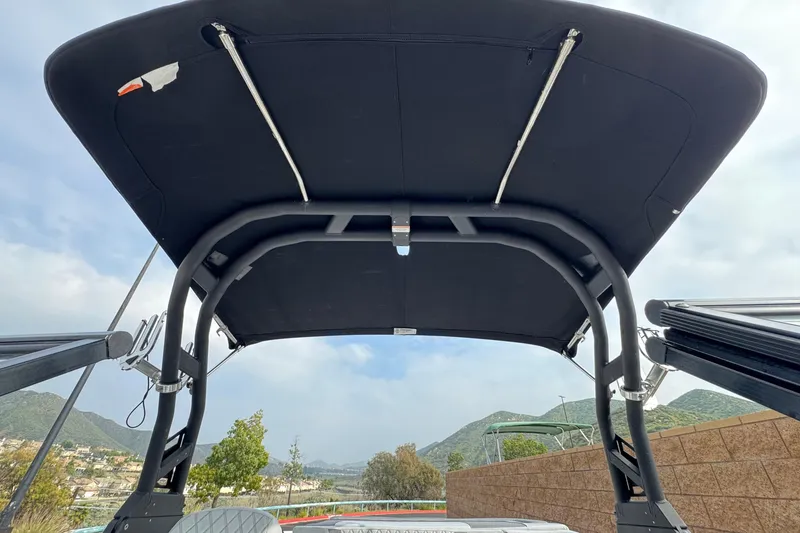 Slide: The Image of 2022 Bayliner VR5 Bowrider I/O with black canopy, scenic mountain backdrop. - 10