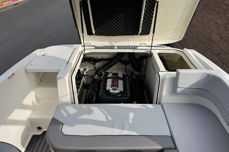 Slide: The Image of 2022 Bayliner VR5 Bowrider I/O engine compartment with open hatch and seating area. - 18