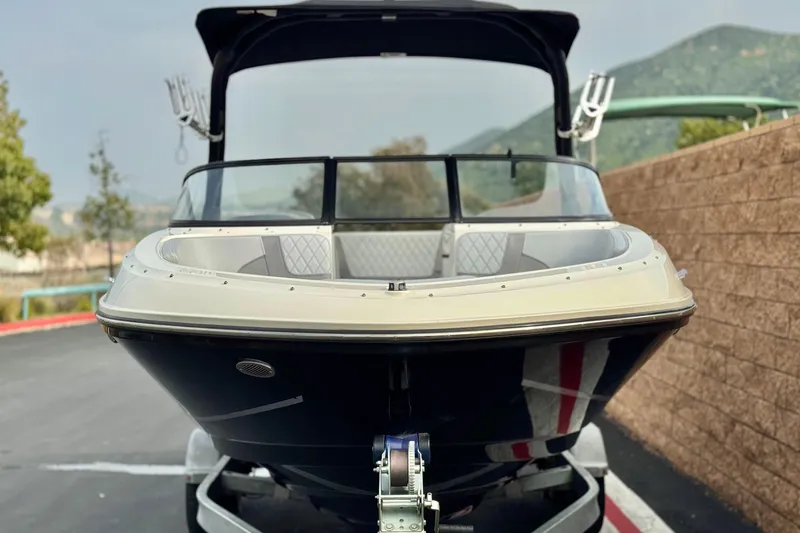 Slide: The Image of 2022 Bayliner VR5 Bowrider I/O boat on trailer, front view, outdoors. - 2