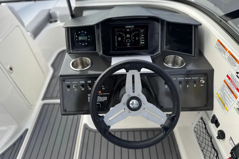 Slide: The Image of 2022 Bayliner VR5 Bowrider I/O dashboard with steering wheel and control panel. - 27