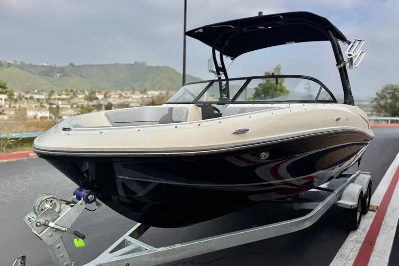 Slide: The Image of 2022 Bayliner VR5 Bowrider I/O on trailer, scenic background, overcast sky. - 3