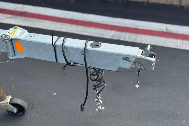 Slide: The Image of Trailer hitch for 2022 Bayliner VR5 Bowrider I/O on asphalt road. - 33