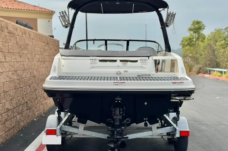 Slide: The Image of 2022 Bayliner VR5 Bowrider I/O on trailer, rear view, parked outdoors. - 4