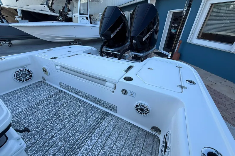 Slide: The Image of 2022 Caymas 28 HB Twin boat with dual Mercury engines, featuring a spacious deck. - 10