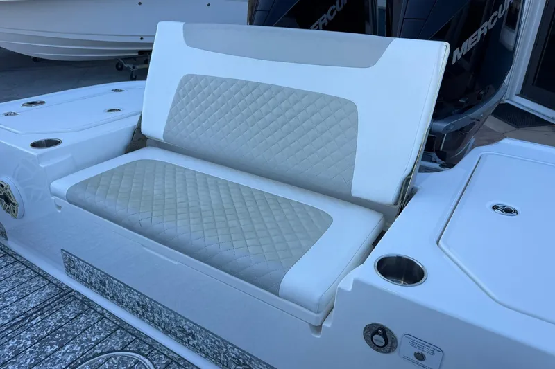 Slide: The Image of 2022 Caymas 28 HB Twin boat with cushioned seating and dual Mercury engines. - 11