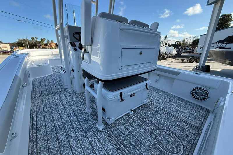 Slide: The Image of 2022 Caymas 28 HB Twin boat interior with seating, storage, and marine speakers. - 15