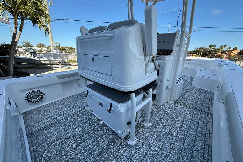 Slide: The Image of 2022 Caymas 28 HB Twin boat interior with seating, storage, and Garmin electronics. - 16