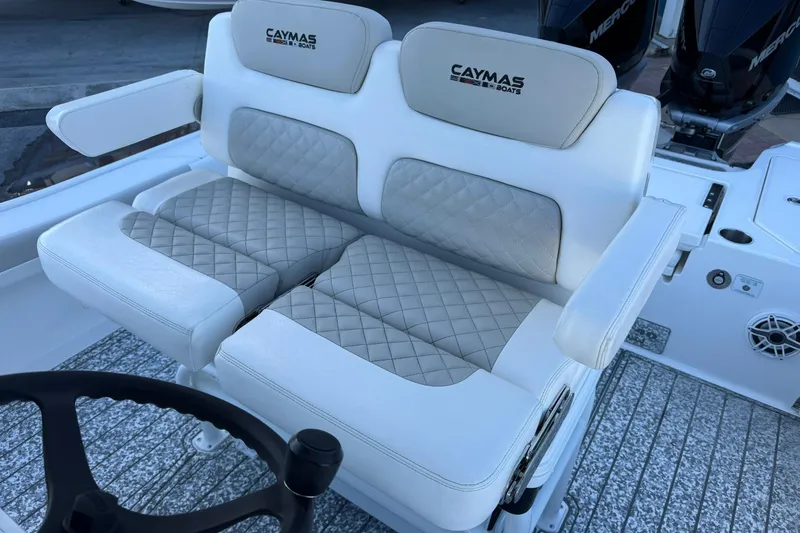 Slide: The Image of Luxury seating on 2022 Caymas 28 HB Twin boat with quilted upholstery and armrests. - 18