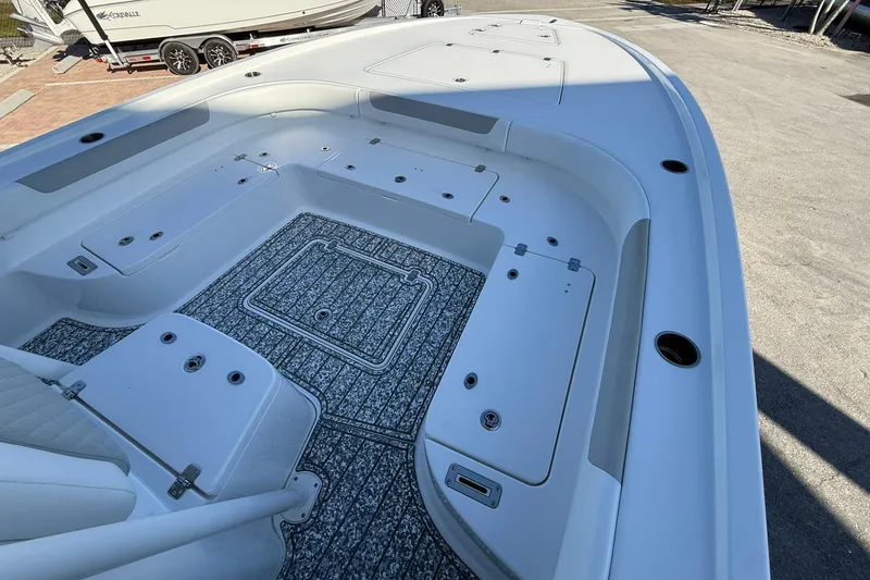 Slide: The Image of 2022 Caymas 28 HB Twin boat interior with storage compartments and non-slip flooring. - 27