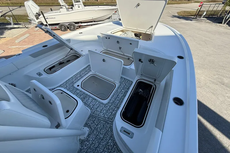 Slide: The Image of 2022 Caymas 28 HB Twin boat with open storage compartments and seating. - 28
