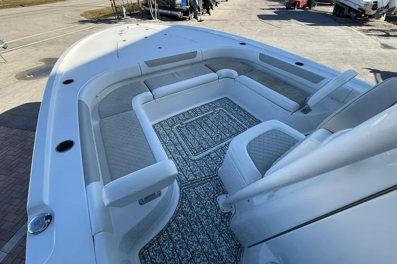 Slide: The Image of 2022 Caymas 28 HB Twin boat interior with cushioned seating and patterned flooring. - 29