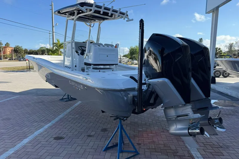 Slide: The Image of 2022 Caymas 28 HB Twin boat with dual engines on display in a sunny outdoor setting. - 3