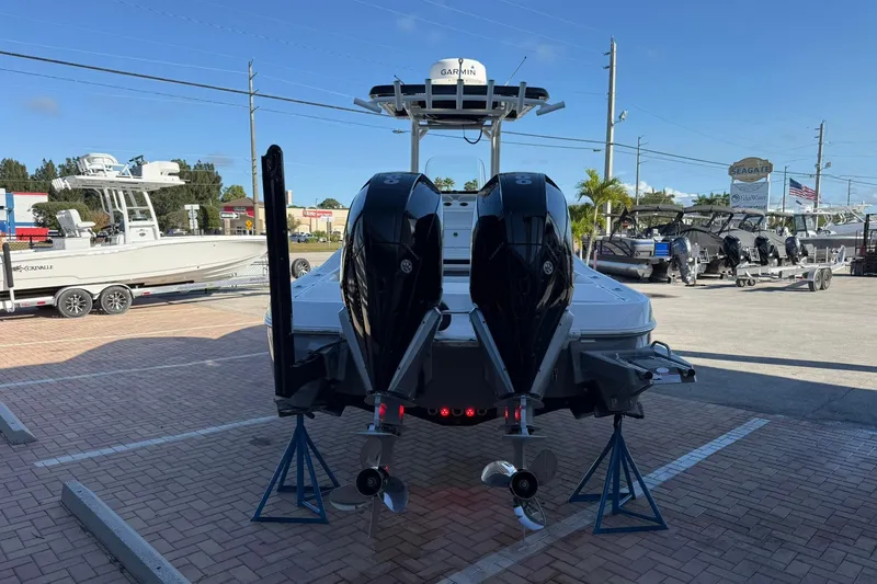 Slide: The Image of 2022 Caymas 28 HB Twin boat with dual engines on display in a marina. - 4