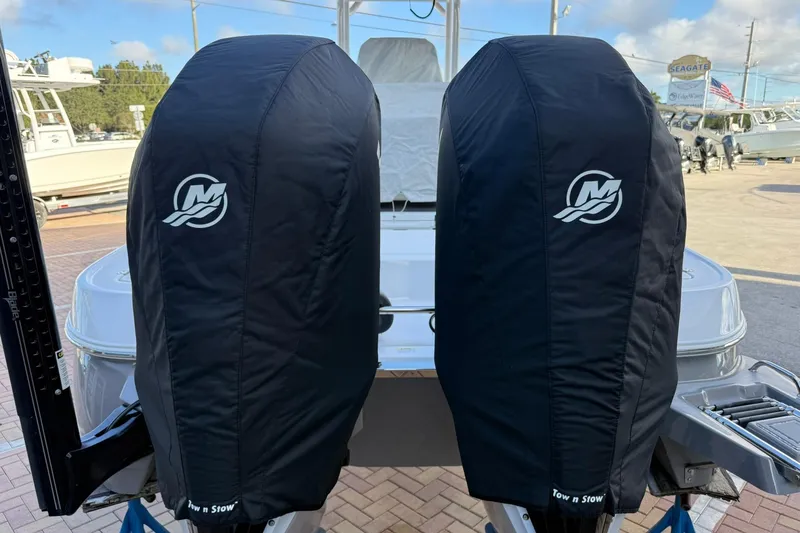 Slide: The Image of Twin outboard motors on a 2022 Caymas 28 HB, covered with protective black covers. - 5