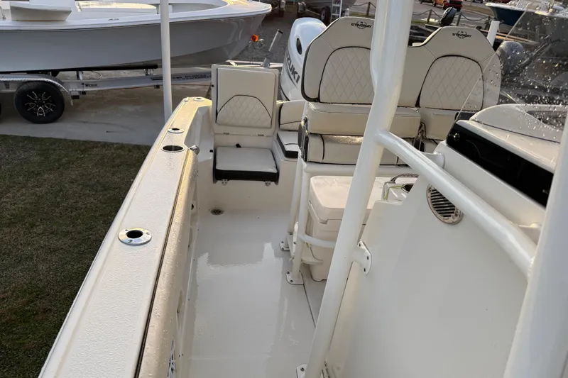 Slide: The Image of 2022 Stingray 216 CC boat interior with seating and fishing rod holders. - 23