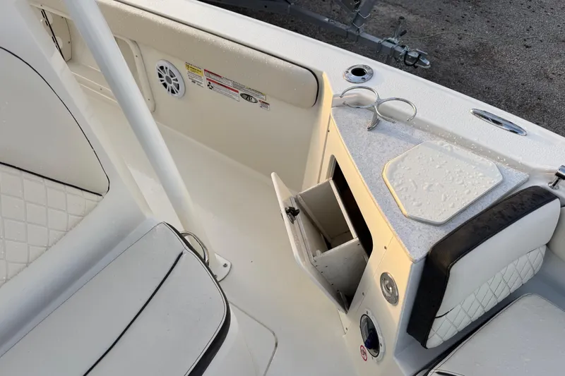 Slide: The Image of 2022 Stingray 216 CC boat interior with storage compartment and seating. - 25