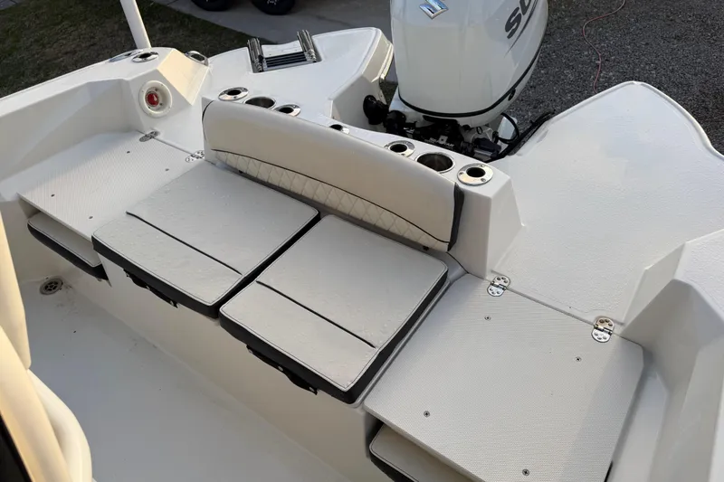 Slide: The Image of 2022 Stingray 216 CC boat interior with seating and motor, showcasing modern design. - 28
