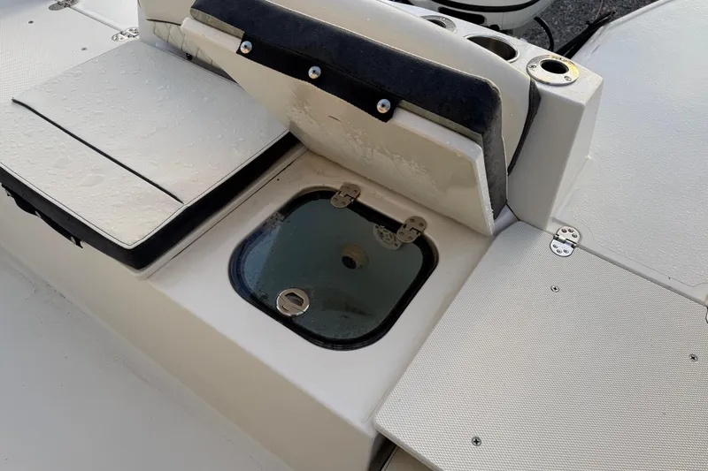 Slide: The Image of 2022 Stingray 216 CC boat interior with storage compartment and seating. - 29