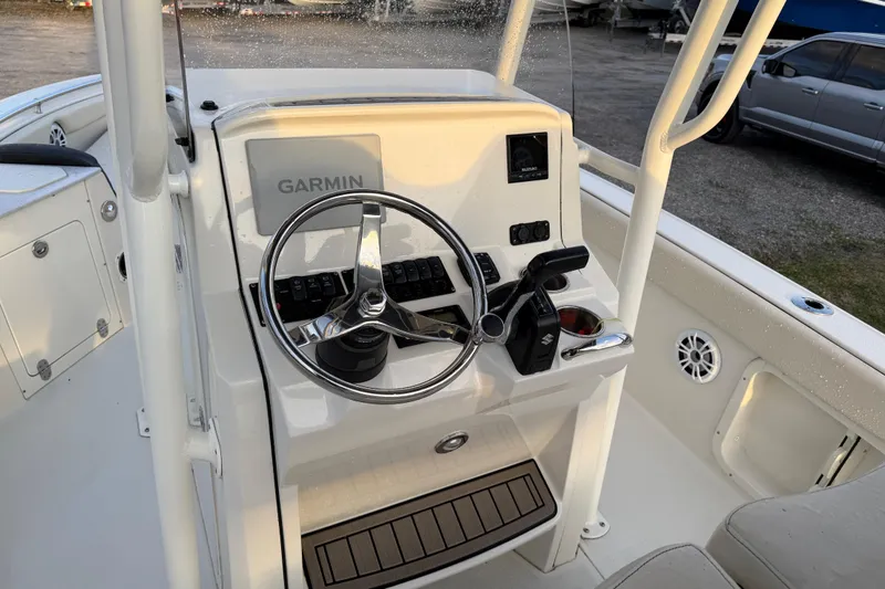 Slide: The Image of 2022 Stingray 216 CC boat console with Garmin navigation and steering wheel. - 30