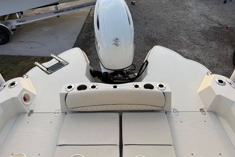 Slide: The Image of 2022 Stingray 216 CC boat stern with motor and seating area. - 35
